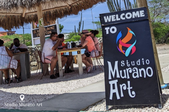 a group of people sitting in front of a sign
