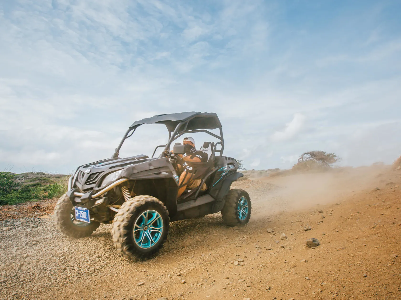 a person riding a motorcycle down a dirt road
