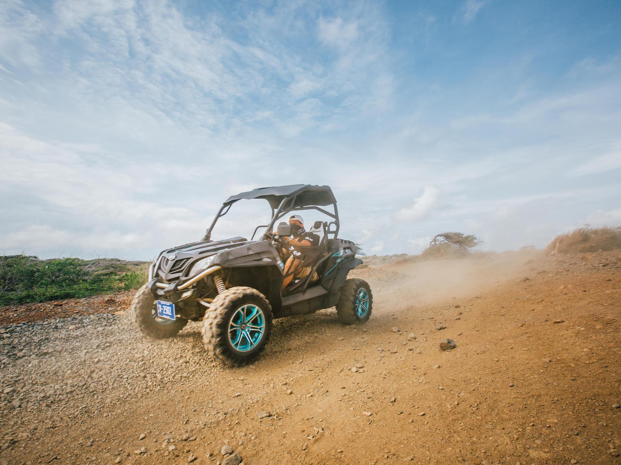 a motorcycle is parked on the side of a dirt field