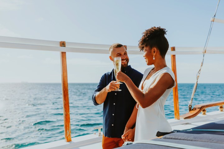 a person standing next to a body of water
