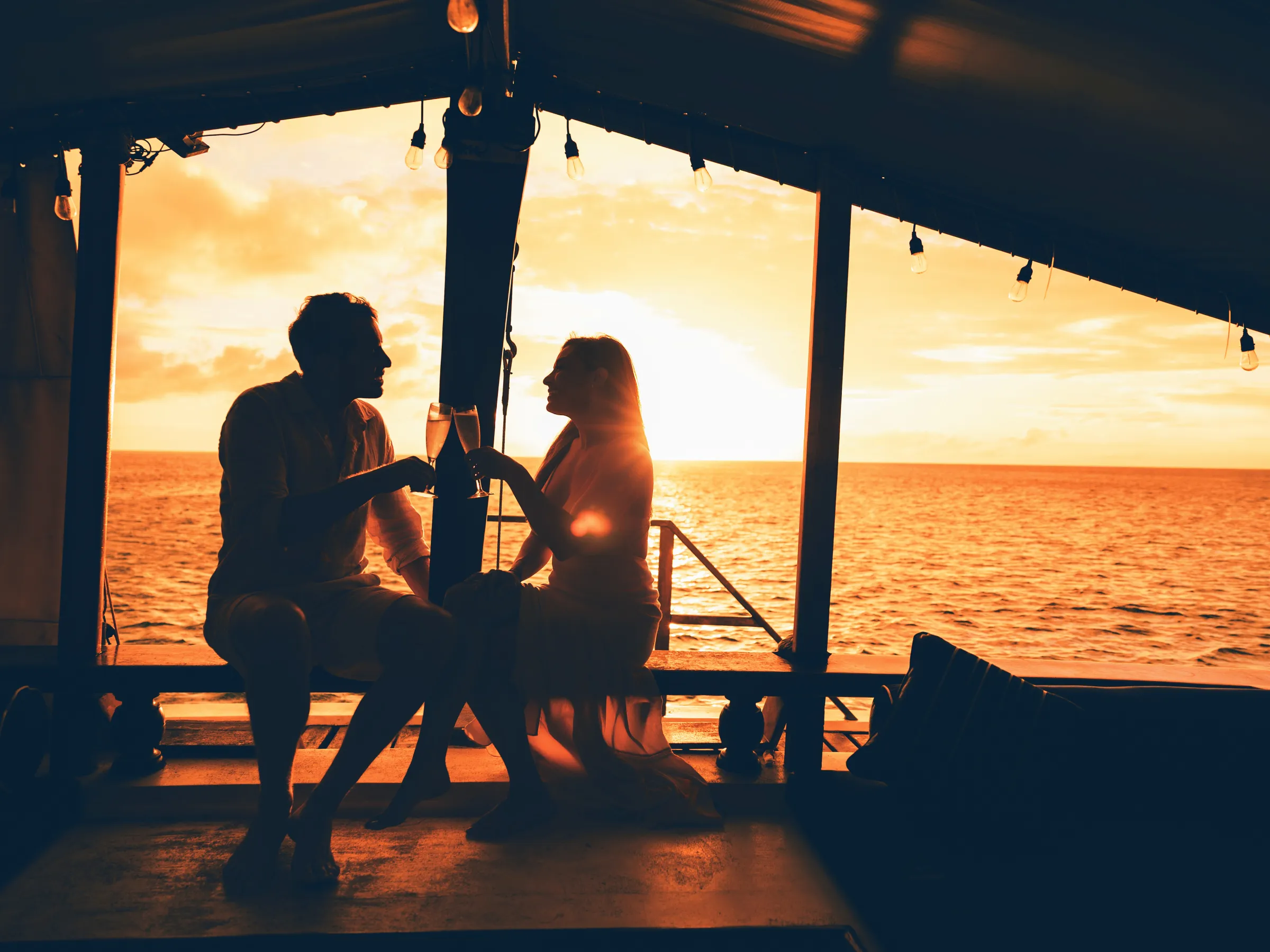 a couple of people that are sitting on a pier