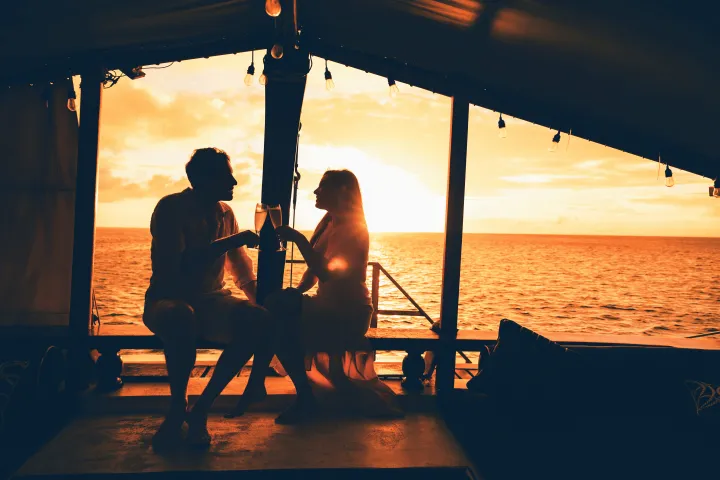 a couple of people that are sitting on a pier