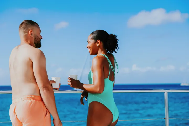 a man and a woman standing next to a body of water