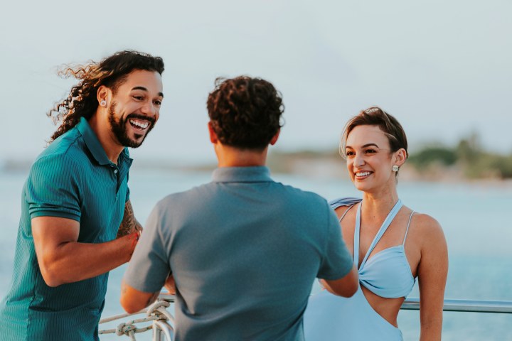 a man standing next to a body of water