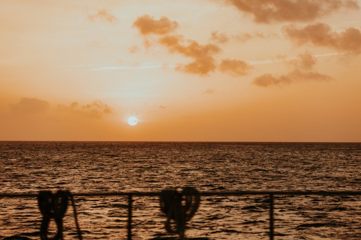 a group of people on a beach near a body of water