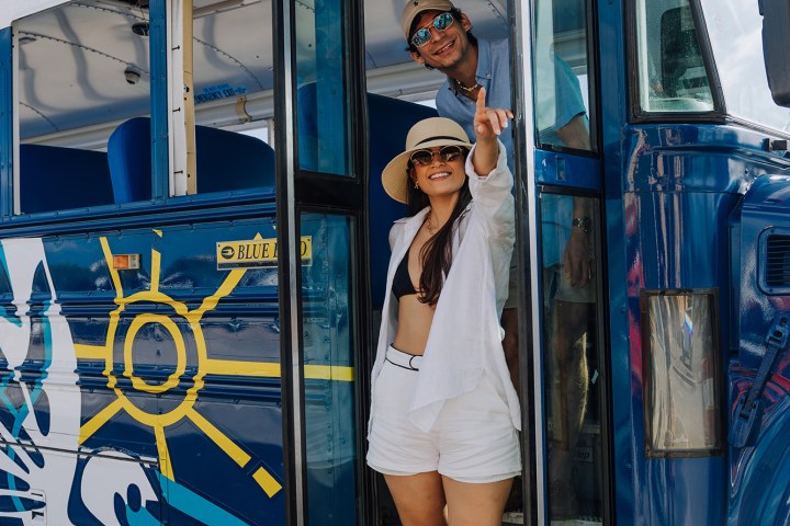 a person standing in front of a bus