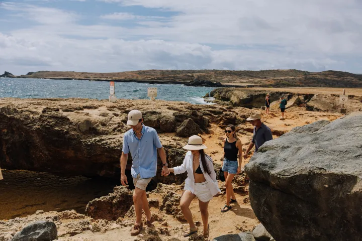 a man standing on a rocky beach