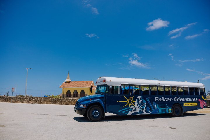 a large tour bus parked in a parking lot