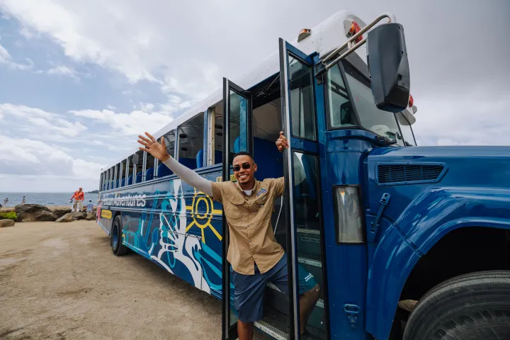 J Alvarez standing in front of a blue truck
