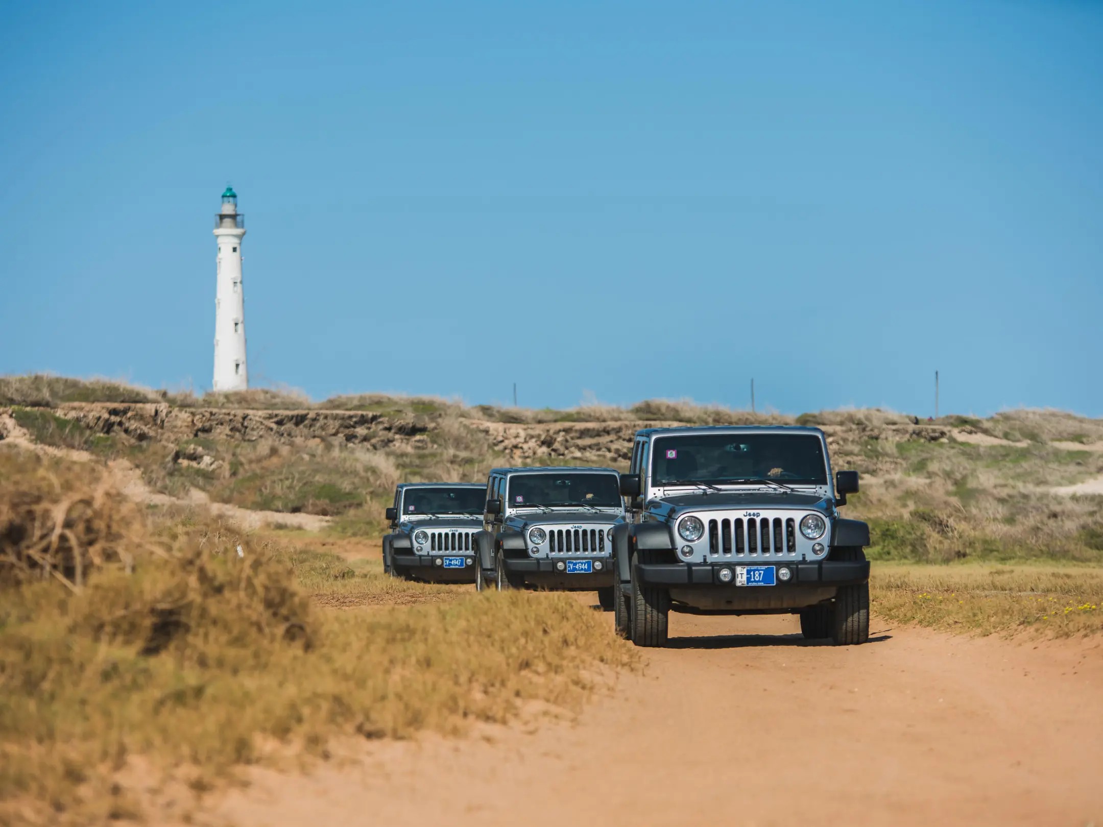 a truck driving down a dirt road