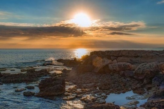 a rocky beach next to a body of water