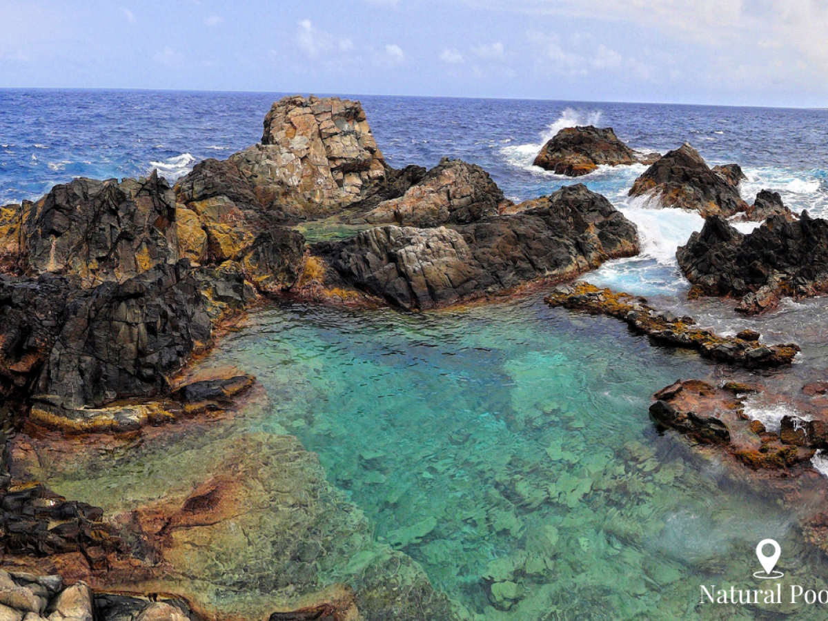a rocky island in the middle of a body of water