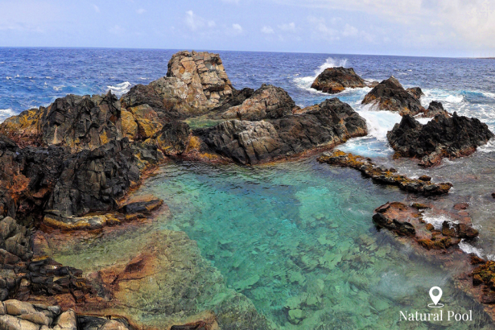 a rocky island in the middle of a body of water