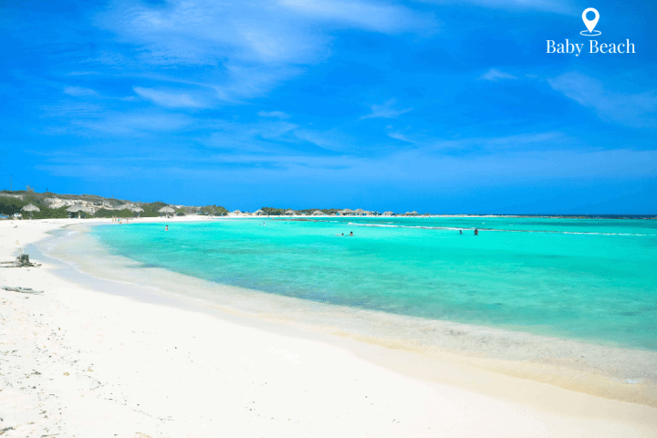 a sandy beach next to a body of water