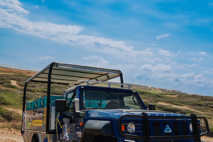 a truck driving down a dirt road