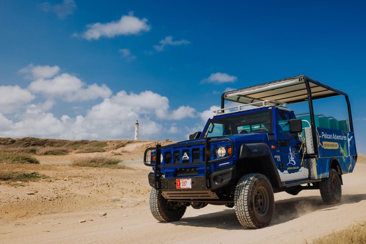 a truck driving down a dirt road