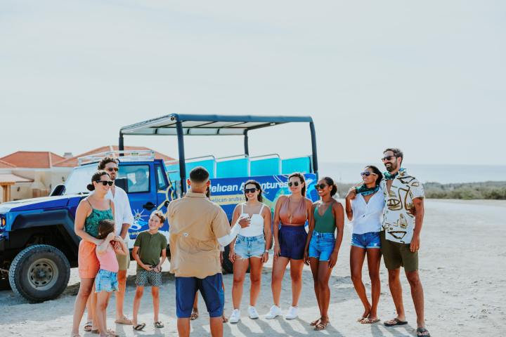 a group of people standing on a beach posing for the camera