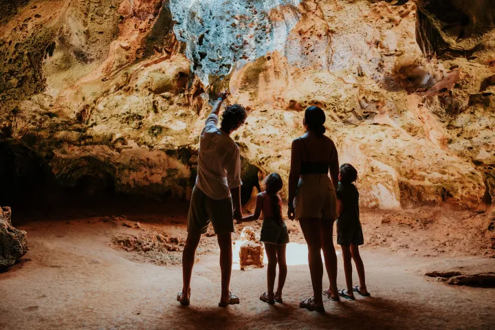 a group of people walking down a dirt road