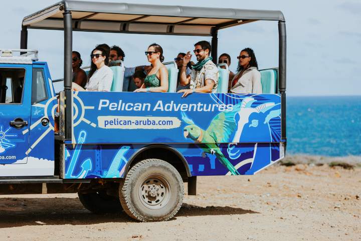 a man standing in front of a blue truck
