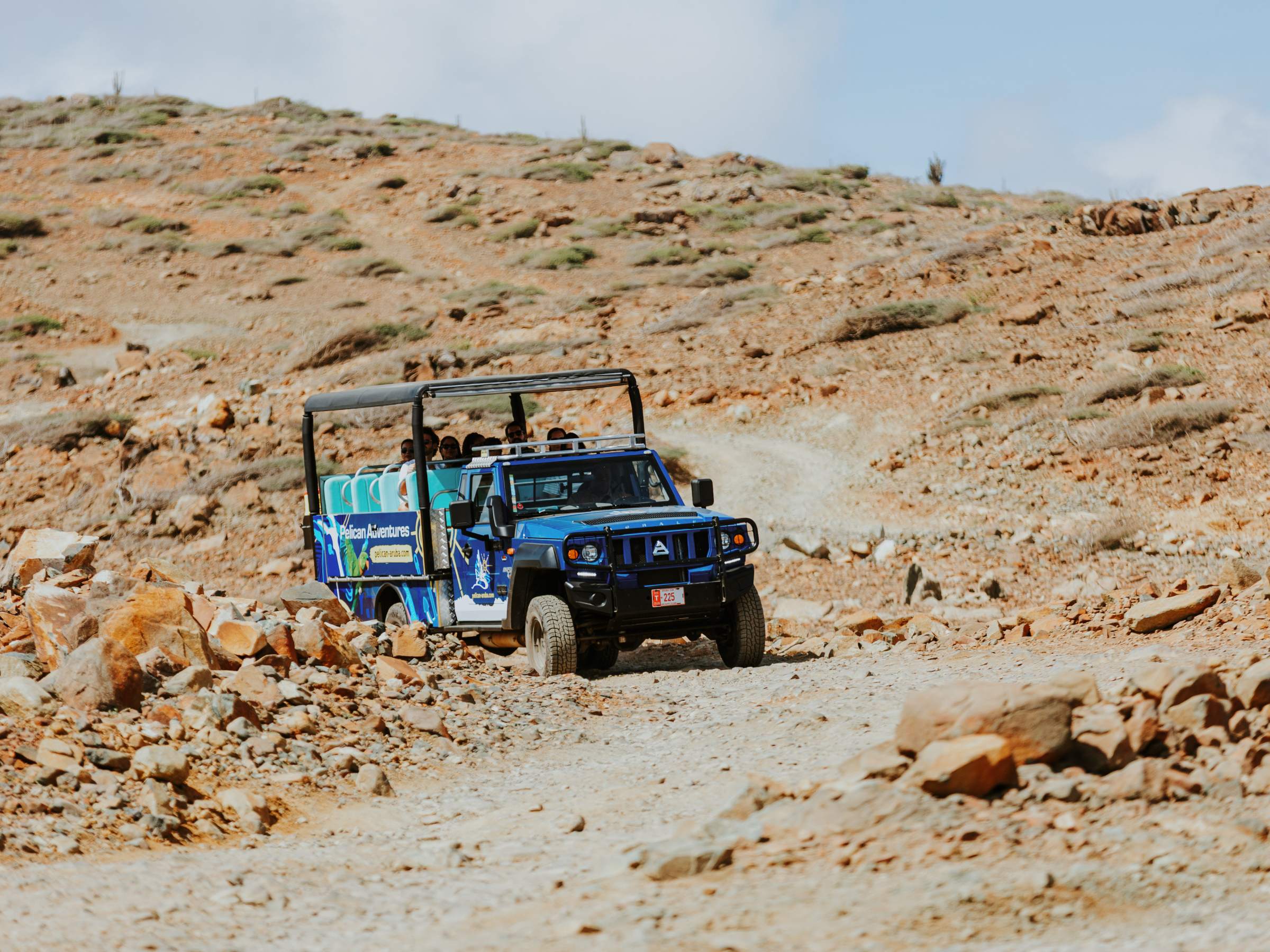 a truck driving down a dirt road