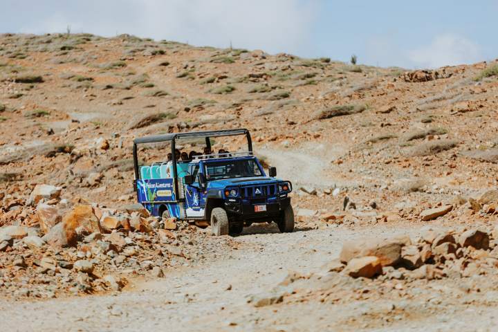 a truck driving down a dirt road