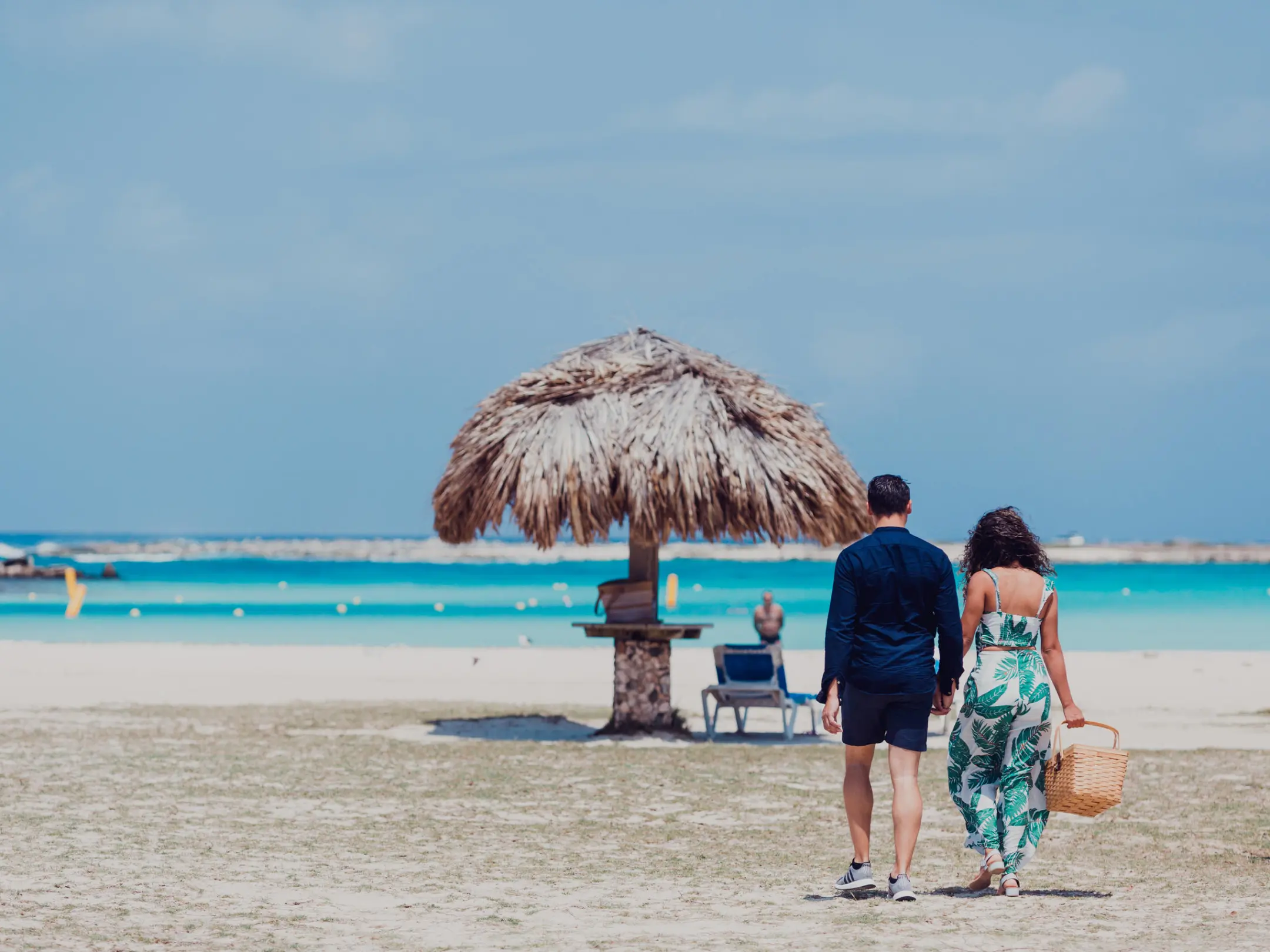 a group of people standing on top of a sandy beach