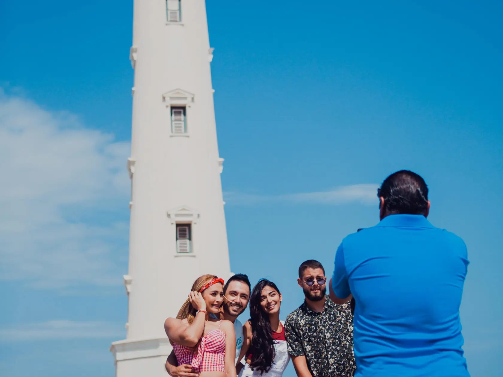 a group of people standing in front of a tower