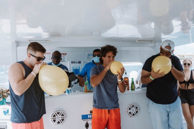a group of people standing in a kitchen