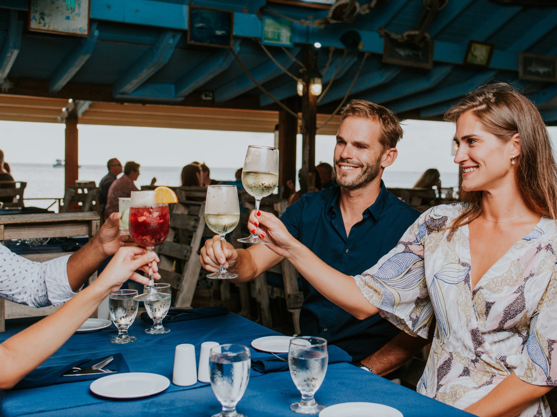 a group of people sitting at a table with wine glasses