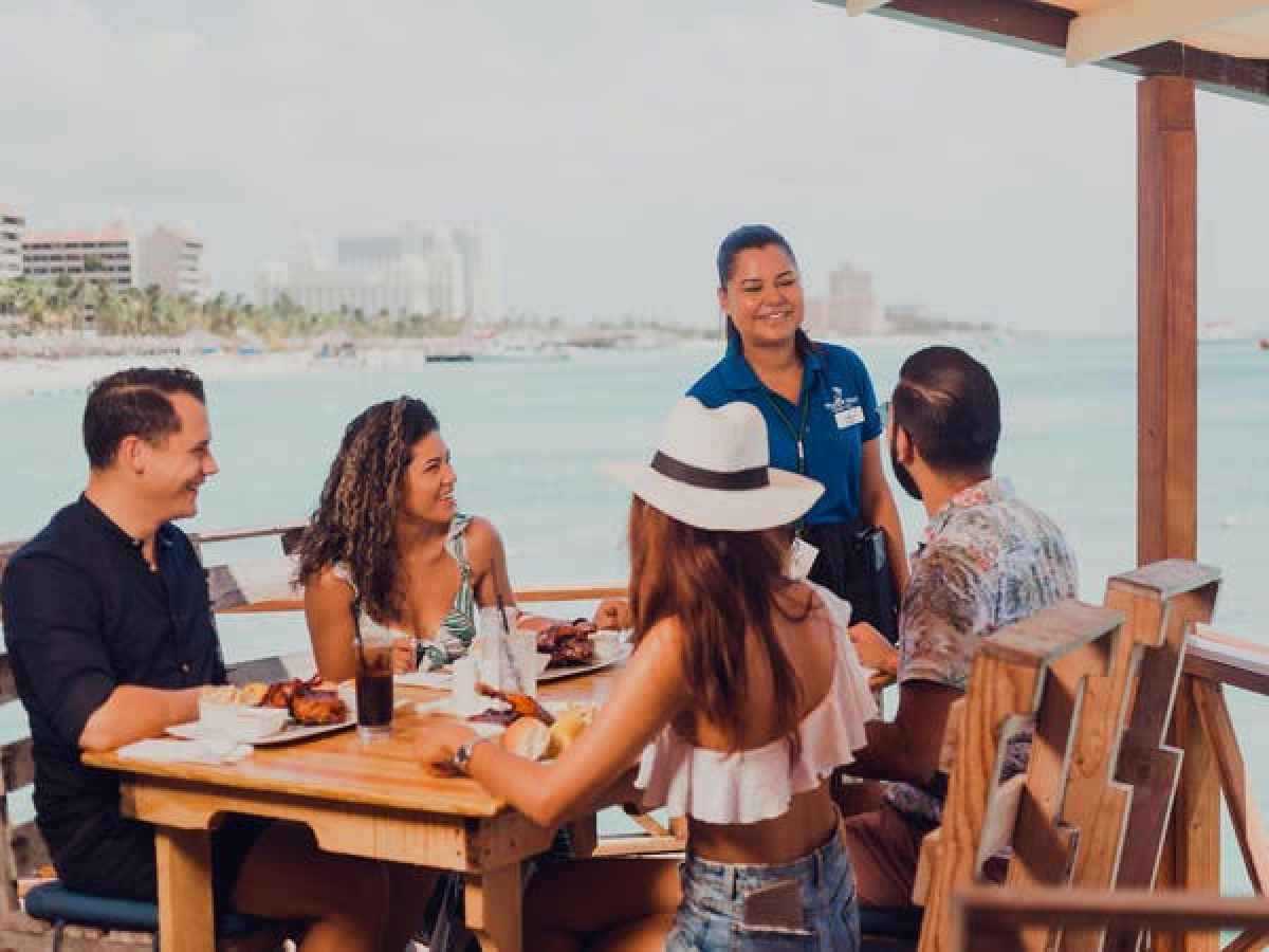 a group of people sitting around a wooden table