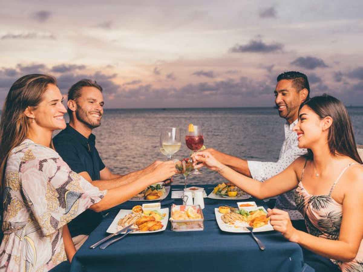 a group of people sitting at a table eating food