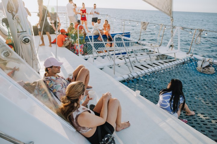 a group of people sitting at a beach