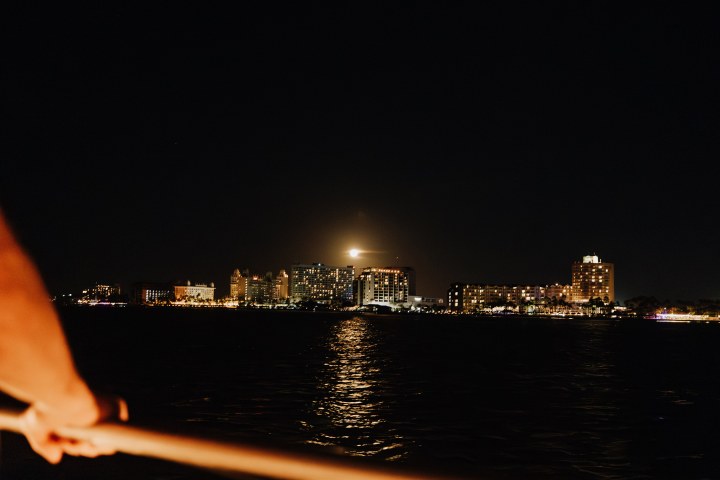 a large body of water with a city in the background