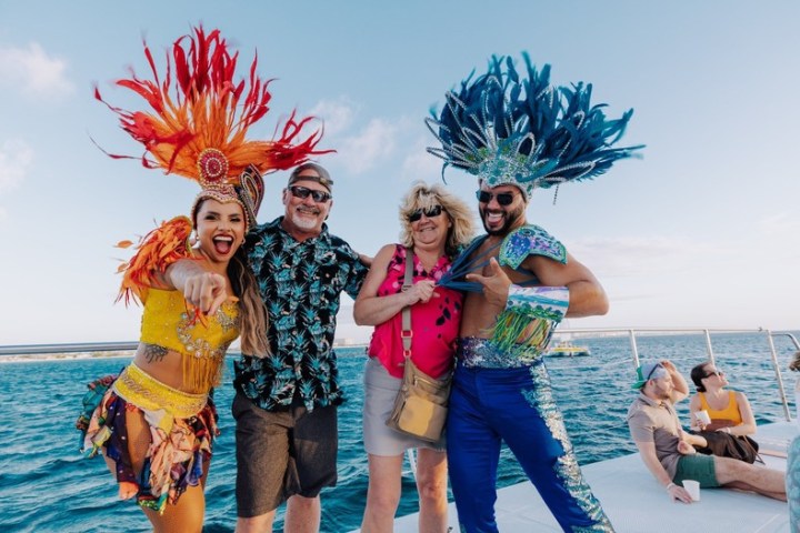 a group of people on a beach posing for the camera