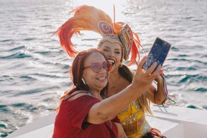 a woman standing next to a body of water